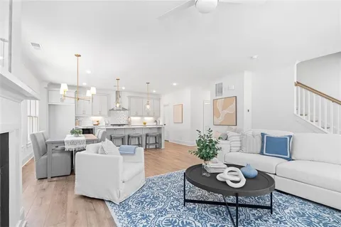 a living room with furniture kitchen view and a table