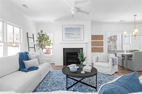 a living room with furniture and a fireplace