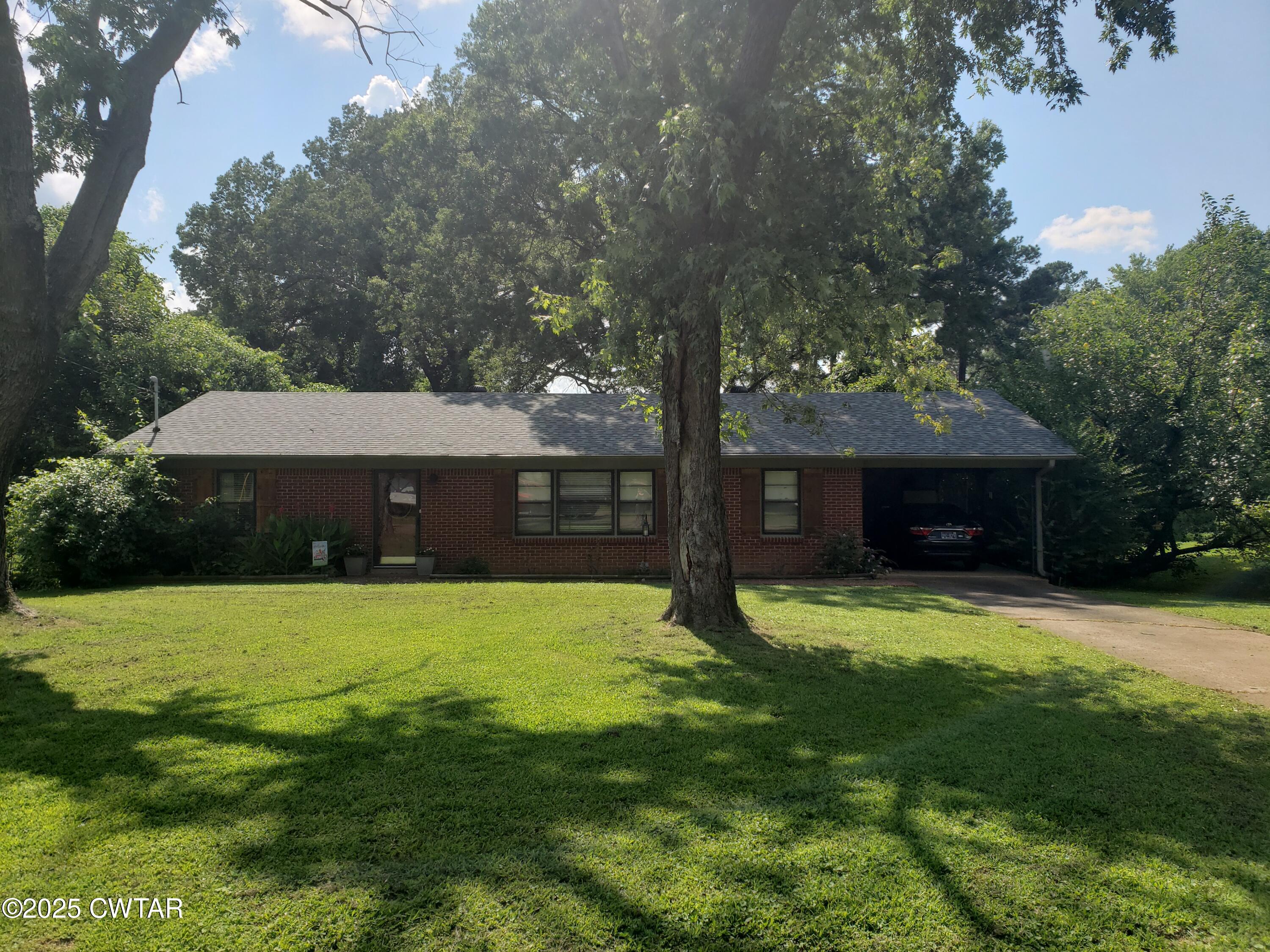 99 Montclair Drive Jackson, TN 38301 - Photo 1 of 19 a house that is sitting in the grass