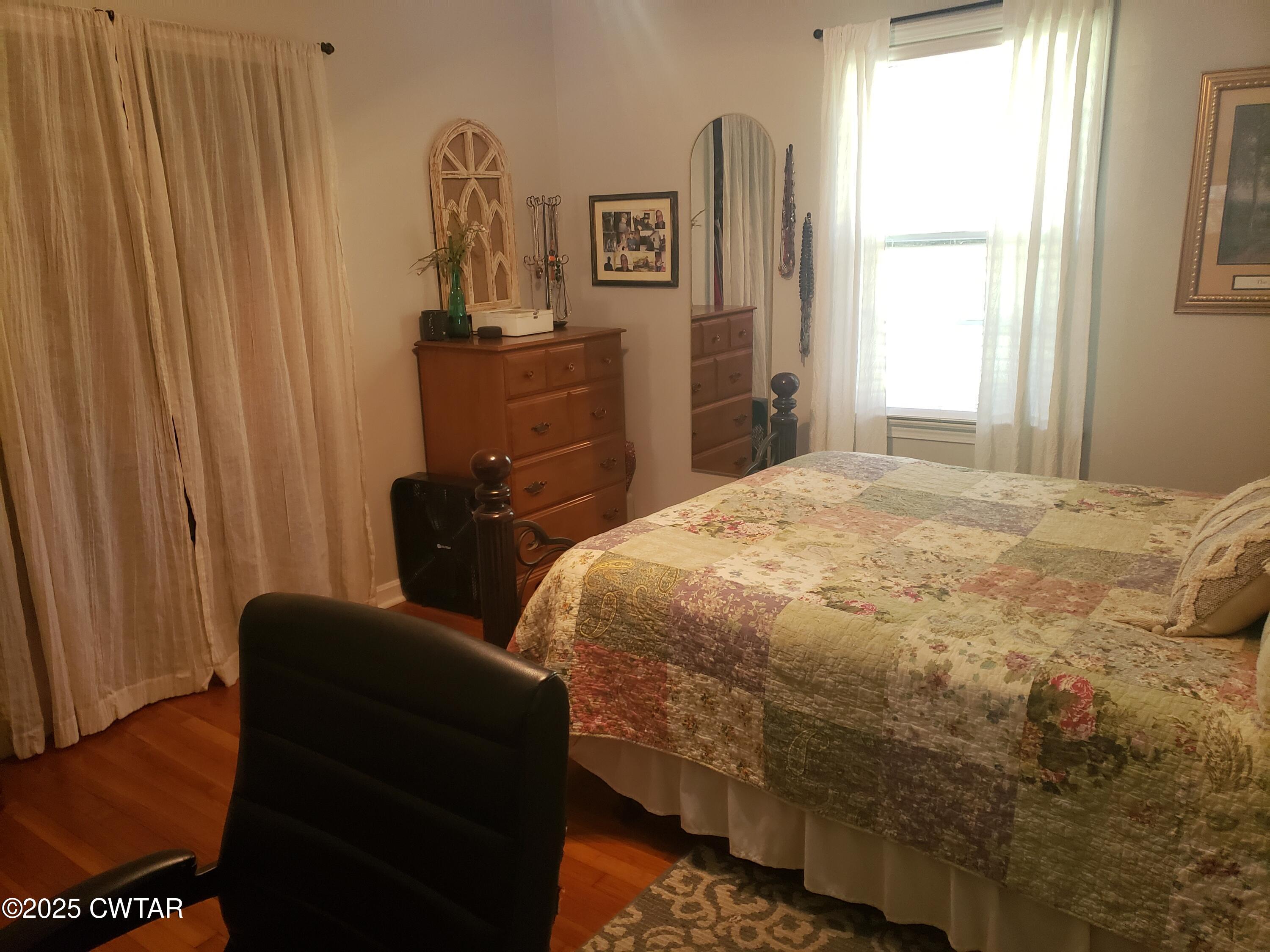 99 Montclair Drive Jackson, TN 38301 - Photo 13 of 19 a bedroom with a bed and wooden floor