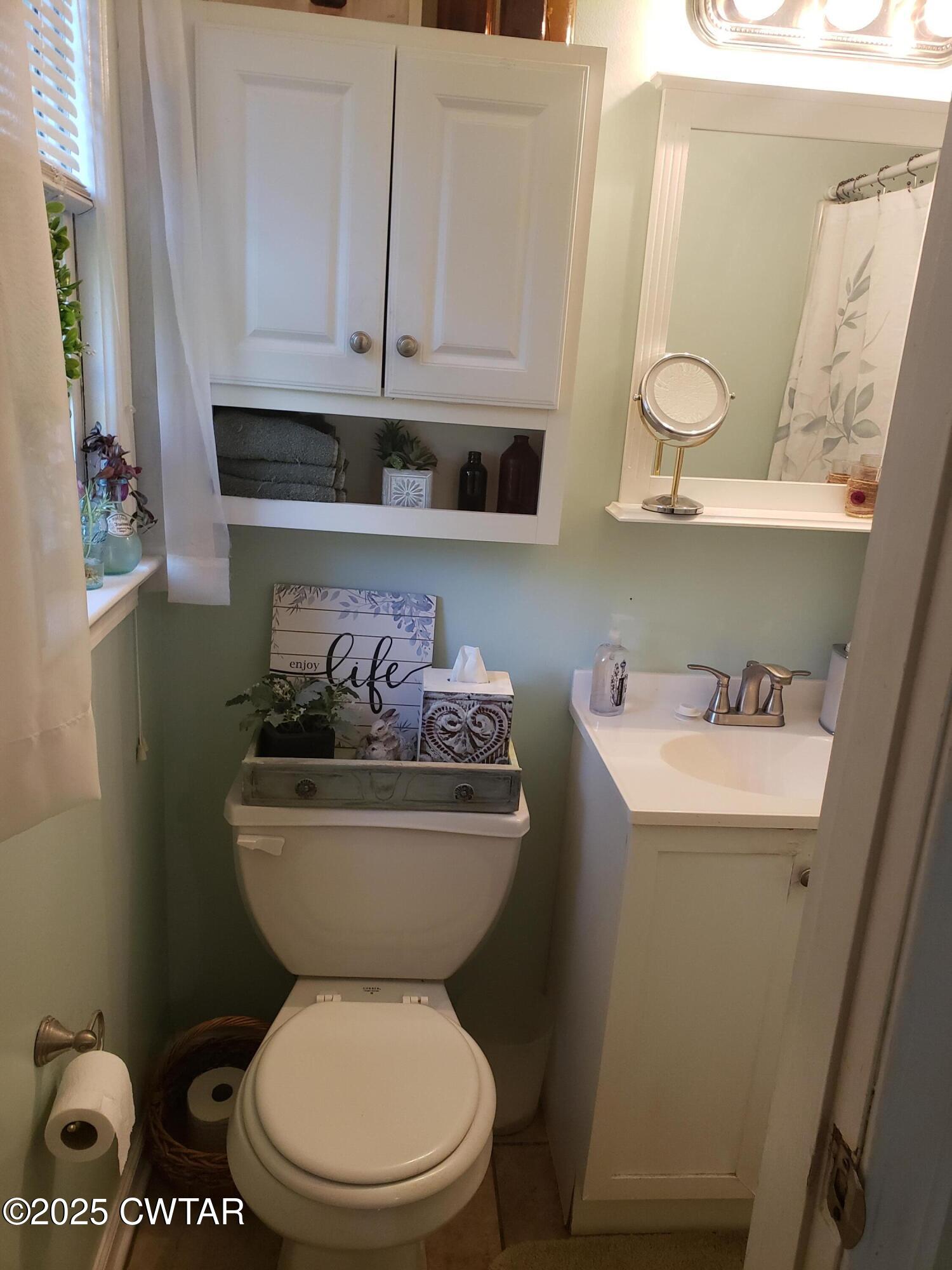 99 Montclair Drive Jackson, TN 38301 - Photo 14 of 19 a bathroom with a toilet a sink and a window