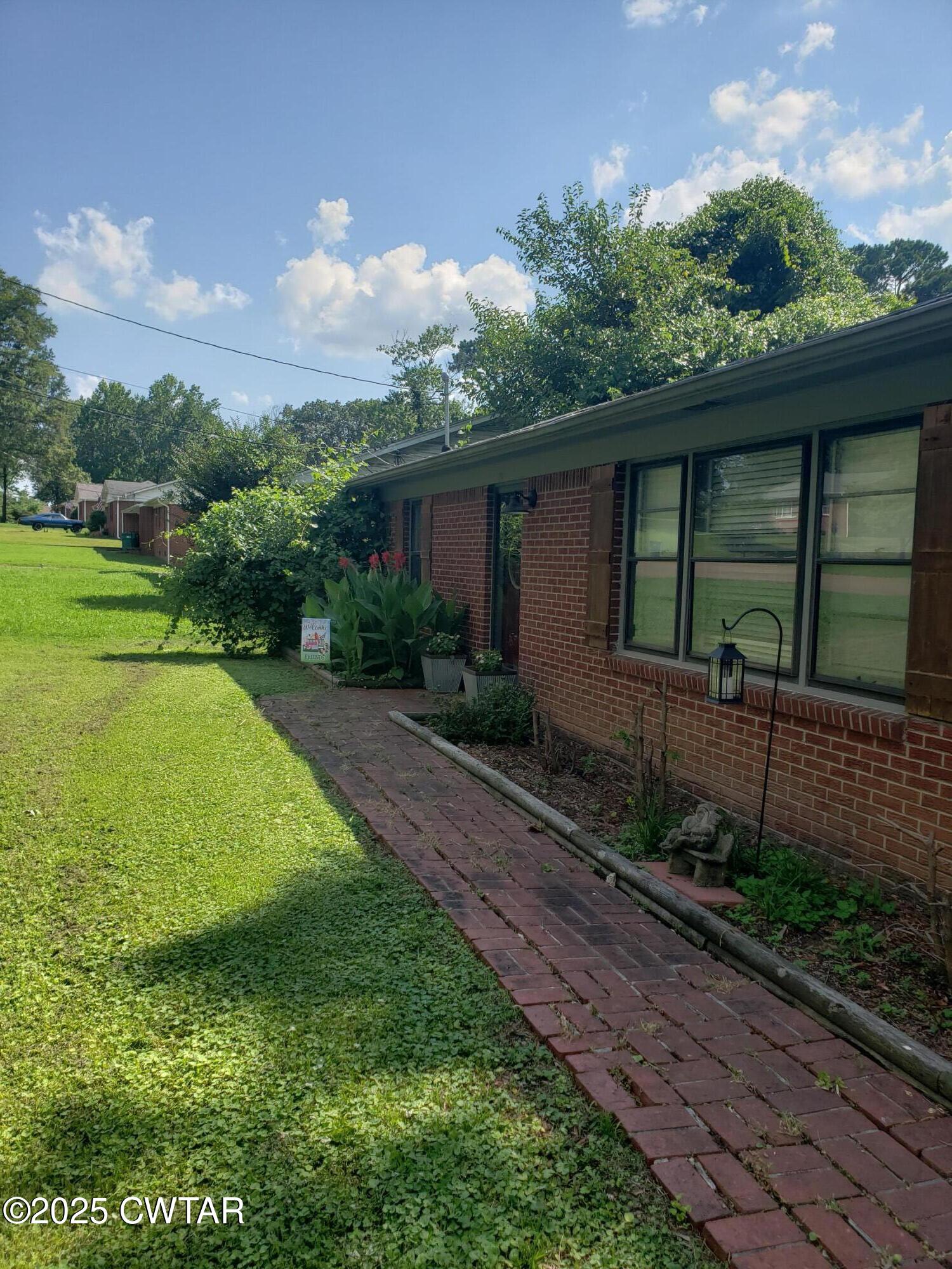 99 Montclair Drive Jackson, TN 38301 - Photo 2 of 19 a view of a backyard with plants and a backyard