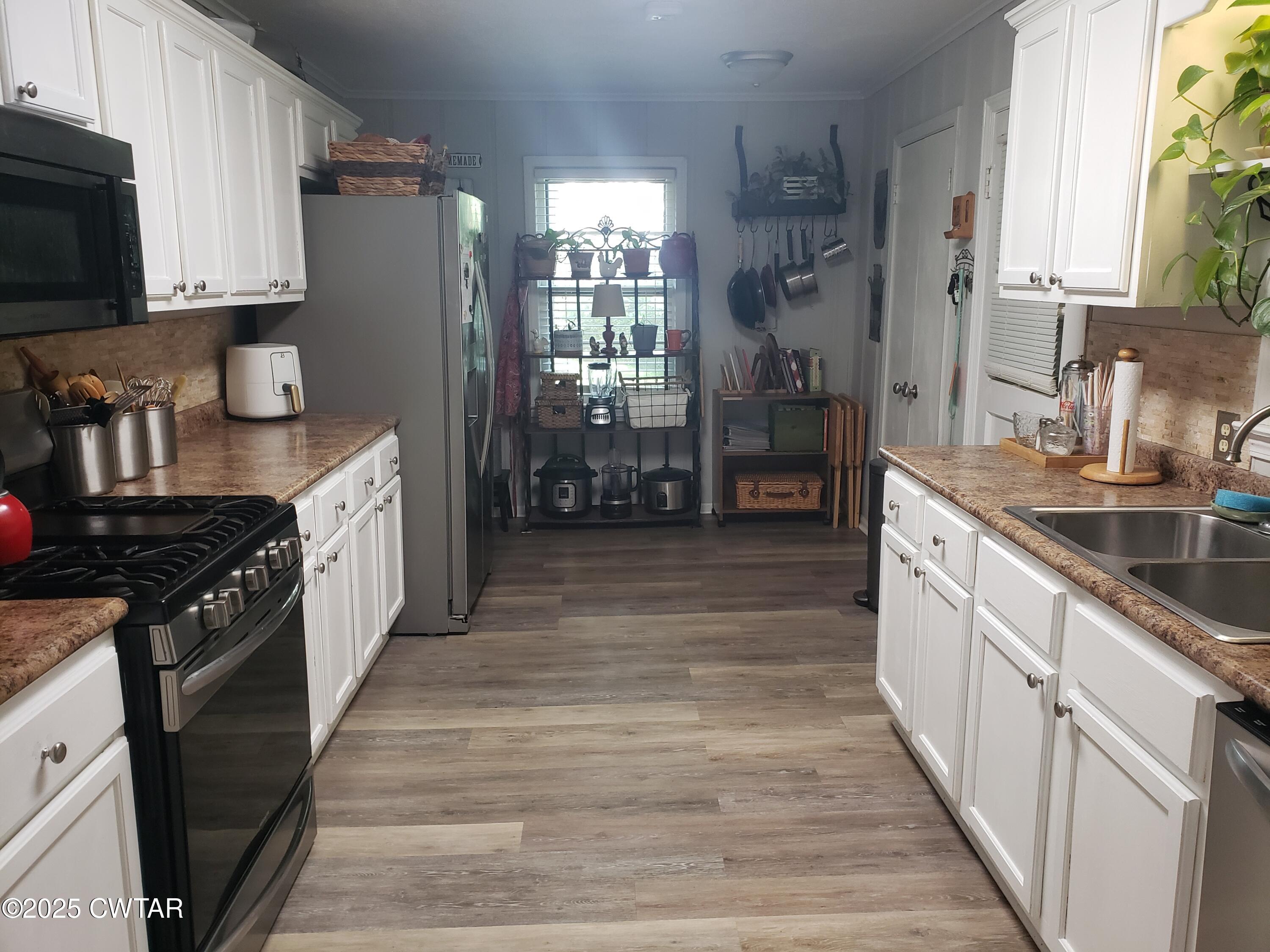 99 Montclair Drive Jackson, TN 38301 - Photo 6 of 19 a large kitchen with stainless steel appliances granite countertop a stove a sink dishwasher and a refrigerator