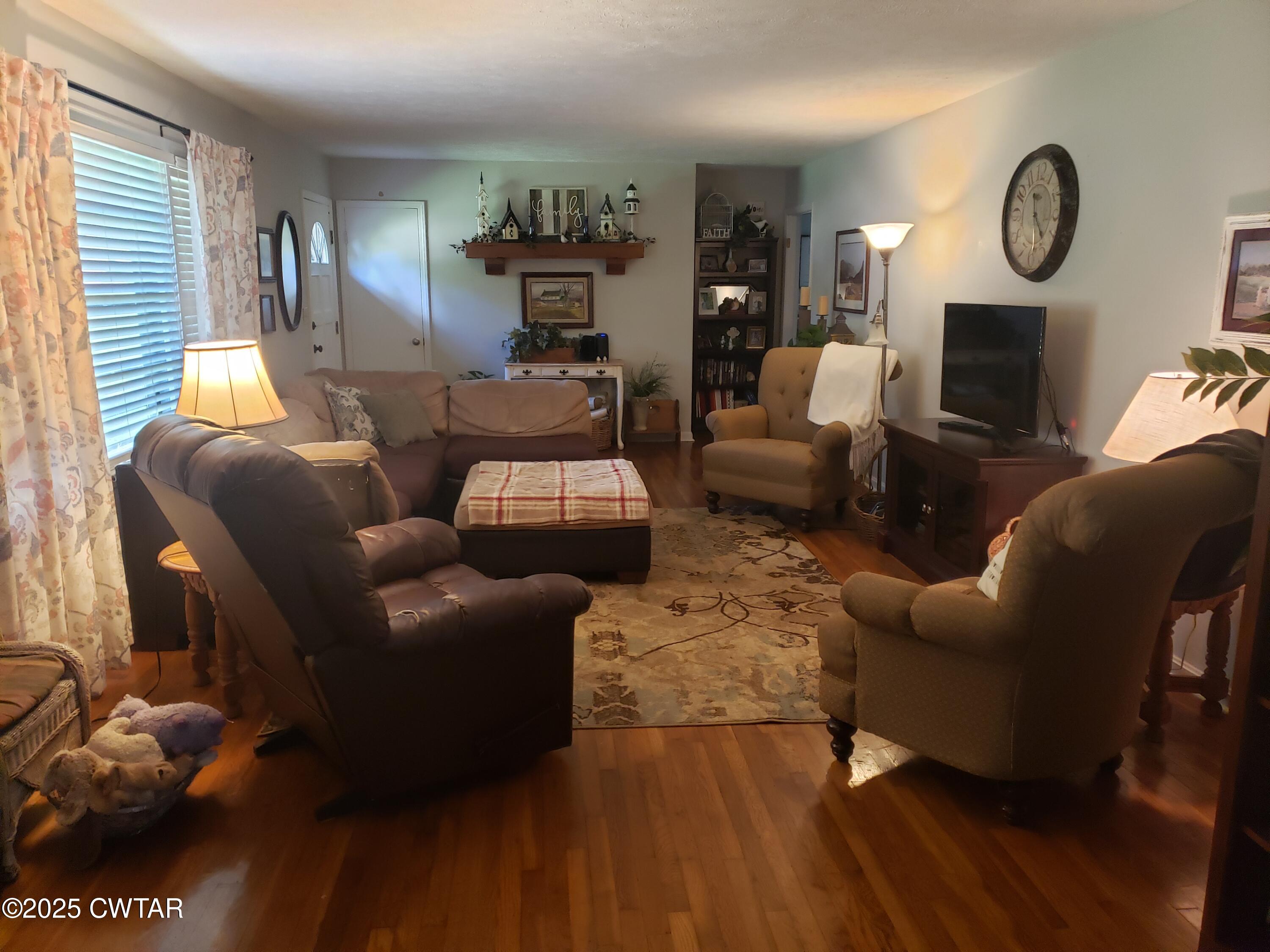 99 Montclair Drive Jackson, TN 38301 - Photo 10 of 19 a living room with furniture a fireplace and a window
