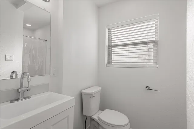 an empty room with a chandelier fan and closet
