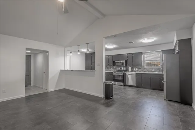 a kitchen with stainless steel appliances granite countertop a sink stove and cabinets