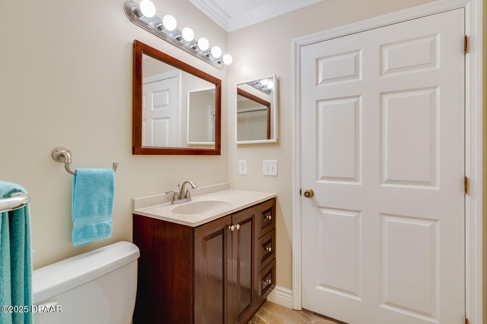 101 Bent Tree Drive, Unit 33 Daytona Beach, FL 32114 - Photo 11 of 27 a bathroom with a toilet a sink and a mirror