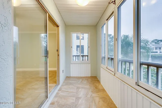a view of a porch with wooden floor and a balcony