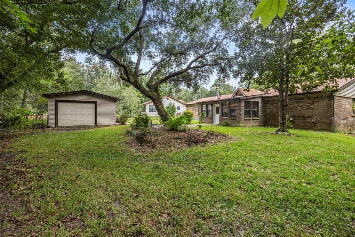 7112 Wells Avenue Navarre, FL 32566 - Photo 38 of 43 a house view with a garden space