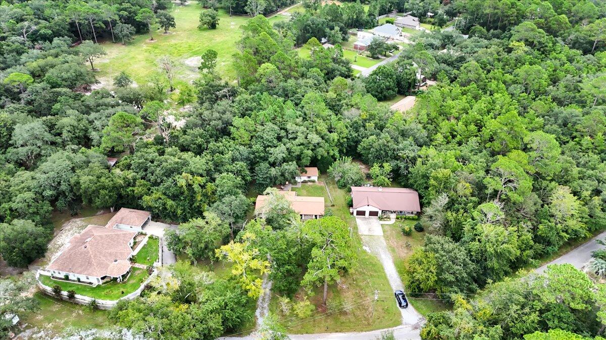 7112 Wells Avenue Navarre, FL 32566 - Photo 42 of 43 an aerial view of residential house with outdoor space and trees all around