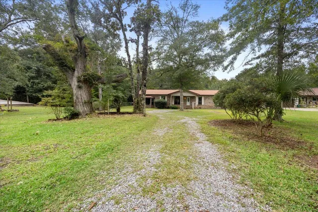 a view of a house with yard and sitting area