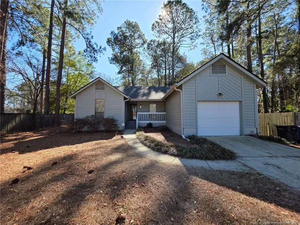 a front view of house with yard and trees
