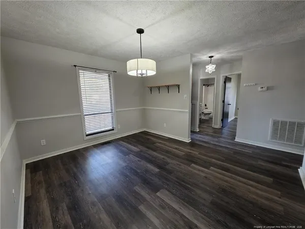a view of wooden floor and windows in a room