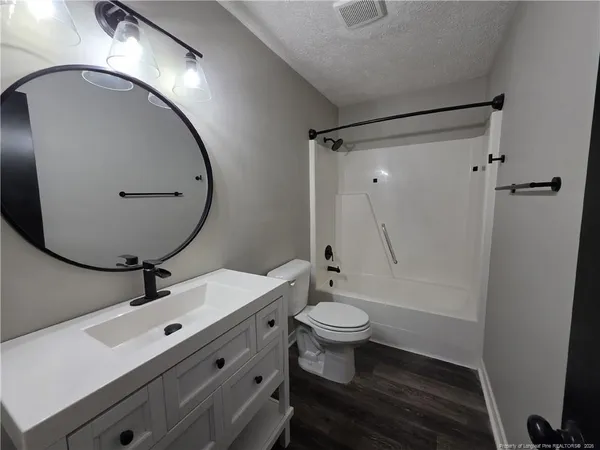 a bathroom with a sink mirror toilet and bathtub