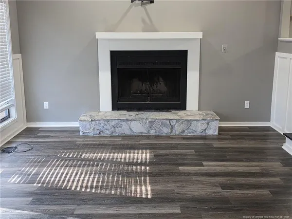 a view of fireplace and wooden floor