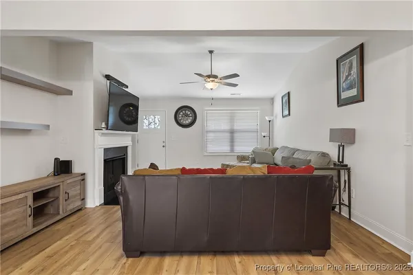 a living room with fireplace furniture and a flat screen tv