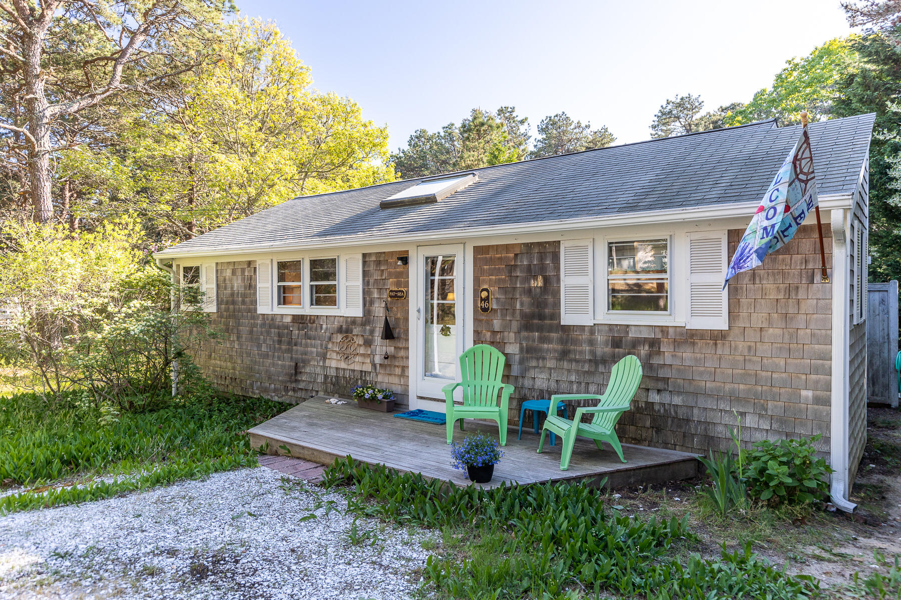 46 King Phillip Road Wellfleet, MA 02667 - Photo 1 of 32 a view of a house with backyard sitting area and garden