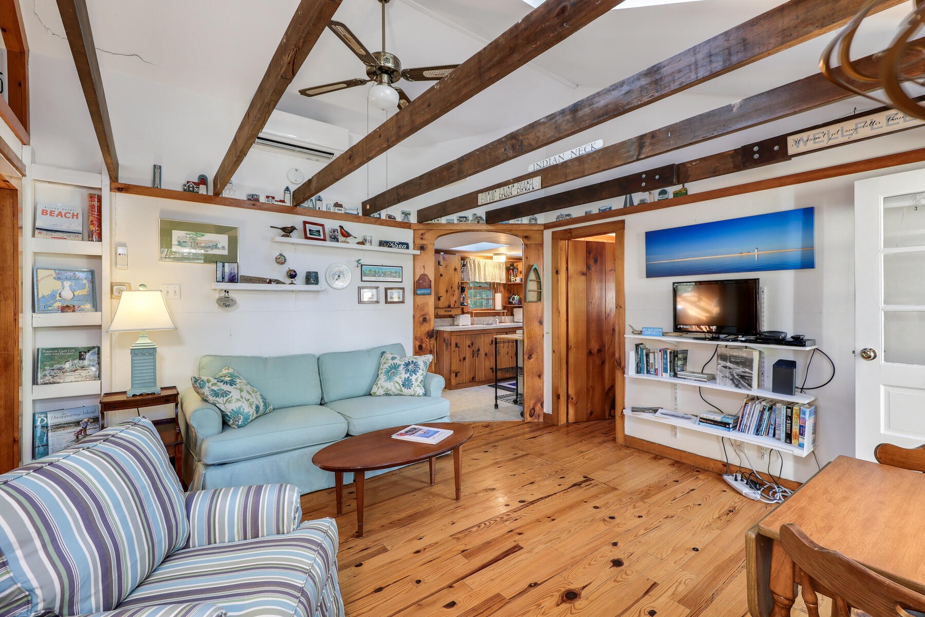 46 King Phillip Road Wellfleet, MA 02667 - Photo 12 of 32 a living room with furniture and a flat screen tv