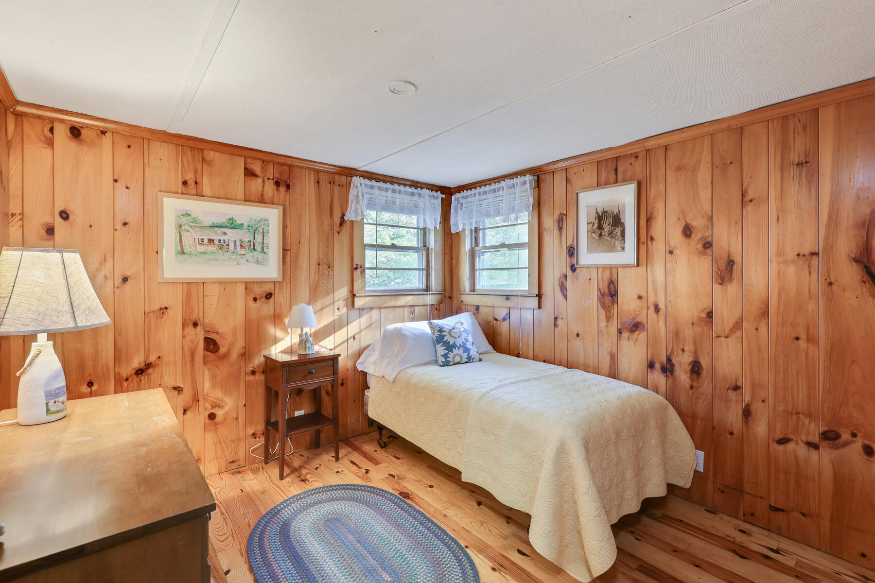 46 King Phillip Road Wellfleet, MA 02667 - Photo 9 of 32 a bedroom with a bed and wooden floor
