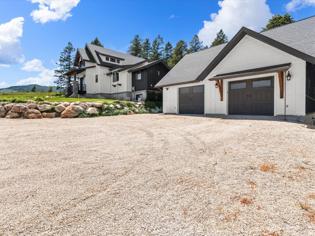 1225 Old Oregon Road Soda Springs, ID 83276 - Photo 56 of 67 Expansive gravel driveway leading to a modern-style residence with a two-car garage