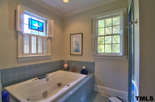 3822 Northampton Road Durham, NC 27707 - Photo 16 of 25 Ceramic tile floor and walls wrap this bath comlete with whirlpool and separate shower.