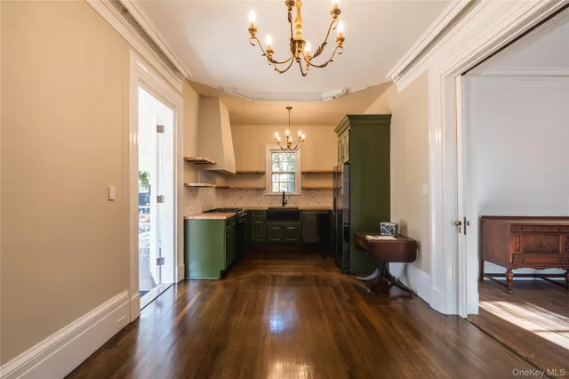 a kitchen with kitchen island a counter top space a sink stainless steel appliances and cabinets