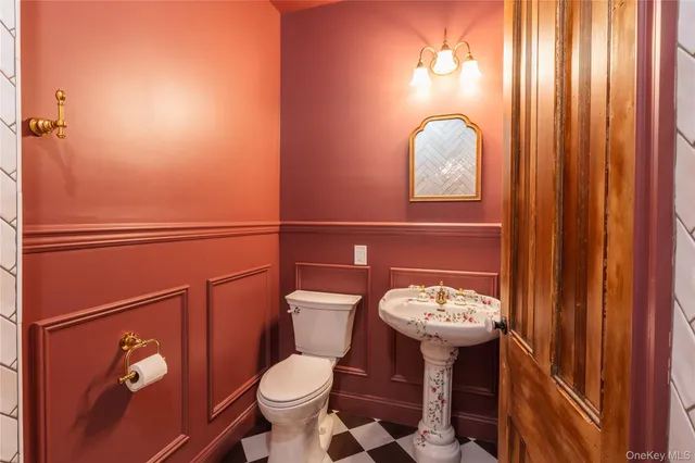 a bathroom with a toilet a sink and mirror