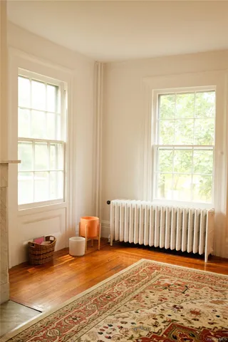 a view of a room with wooden floor and furniture