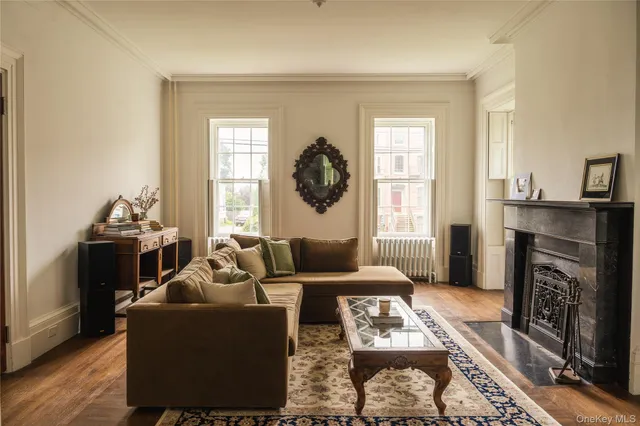 a living room with furniture a fireplace and a window
