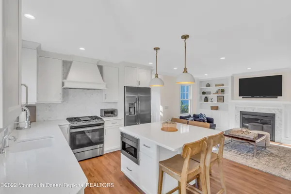 a kitchen with a stove a refrigerator and a kitchen island