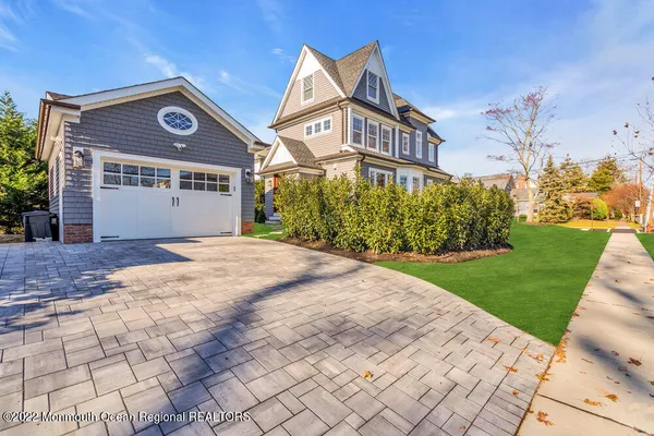 a front view of a house with a yard and a garage