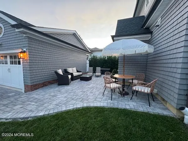 a backyard of a house with table and chairs