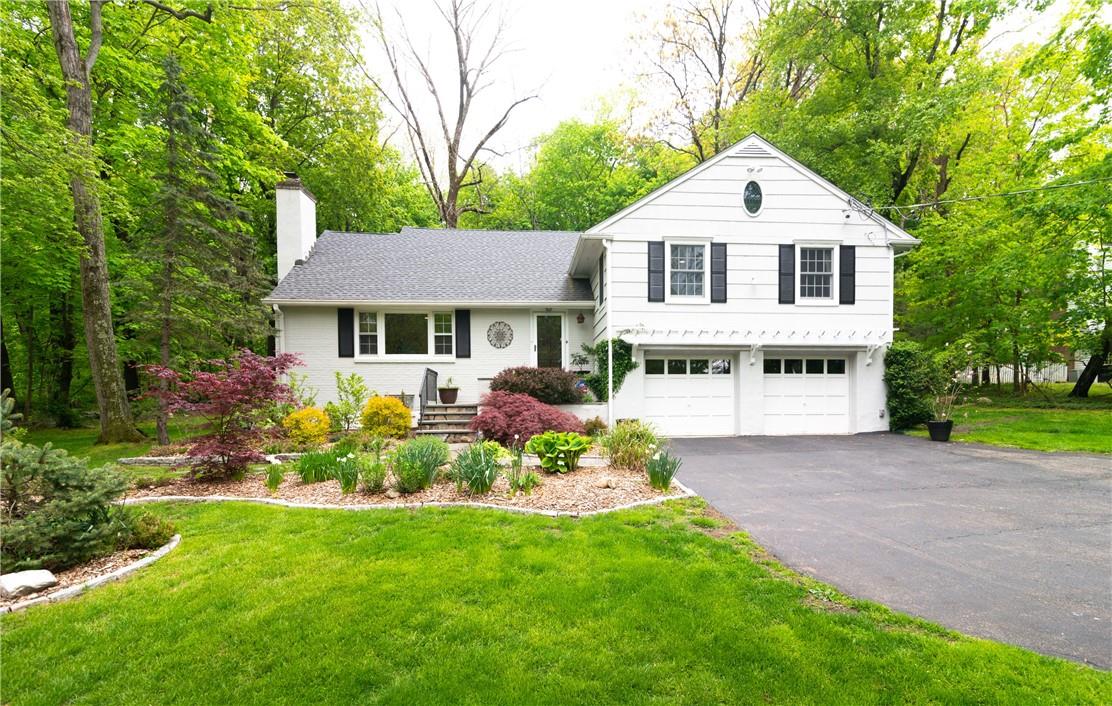 361 Quaker Road Chappaqua, NY 10514 - Photo 1 of 1 a front view of a house with a garden and trees