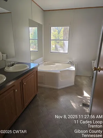 a bathroom with a granite countertop sink a mirror and a vanity
