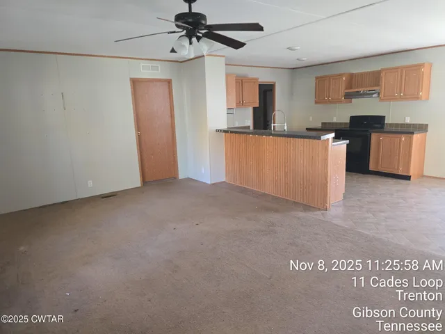 a view of a kitchen with stainless steel appliances granite countertop a refrigerator and a sink