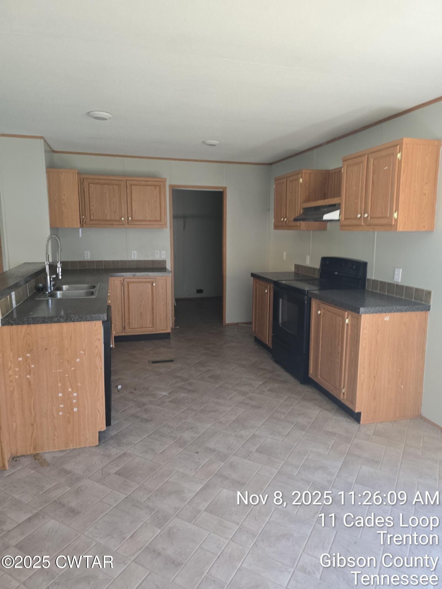 11 Cades Loop Trenton, TN 38382 - Photo 6 of 16 a kitchen with stainless steel appliances granite countertop a sink stove and cabinets