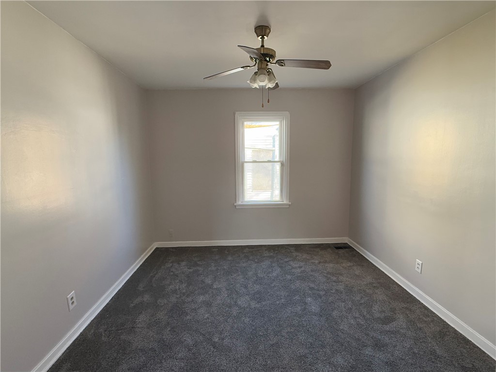955 North McClellan Street Decatur, IL 62522 - Photo 11 of 17 wooden floor in an empty room with a window