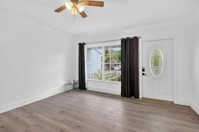 wooden floor in an empty room with a window