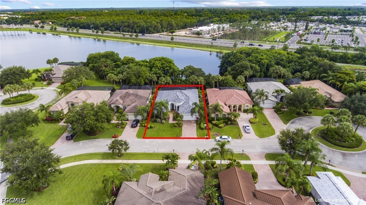 9042 Bronco Court Naples, FL 34113 - Photo 3 of 50 an aerial view of residential houses with outdoor space and lake view