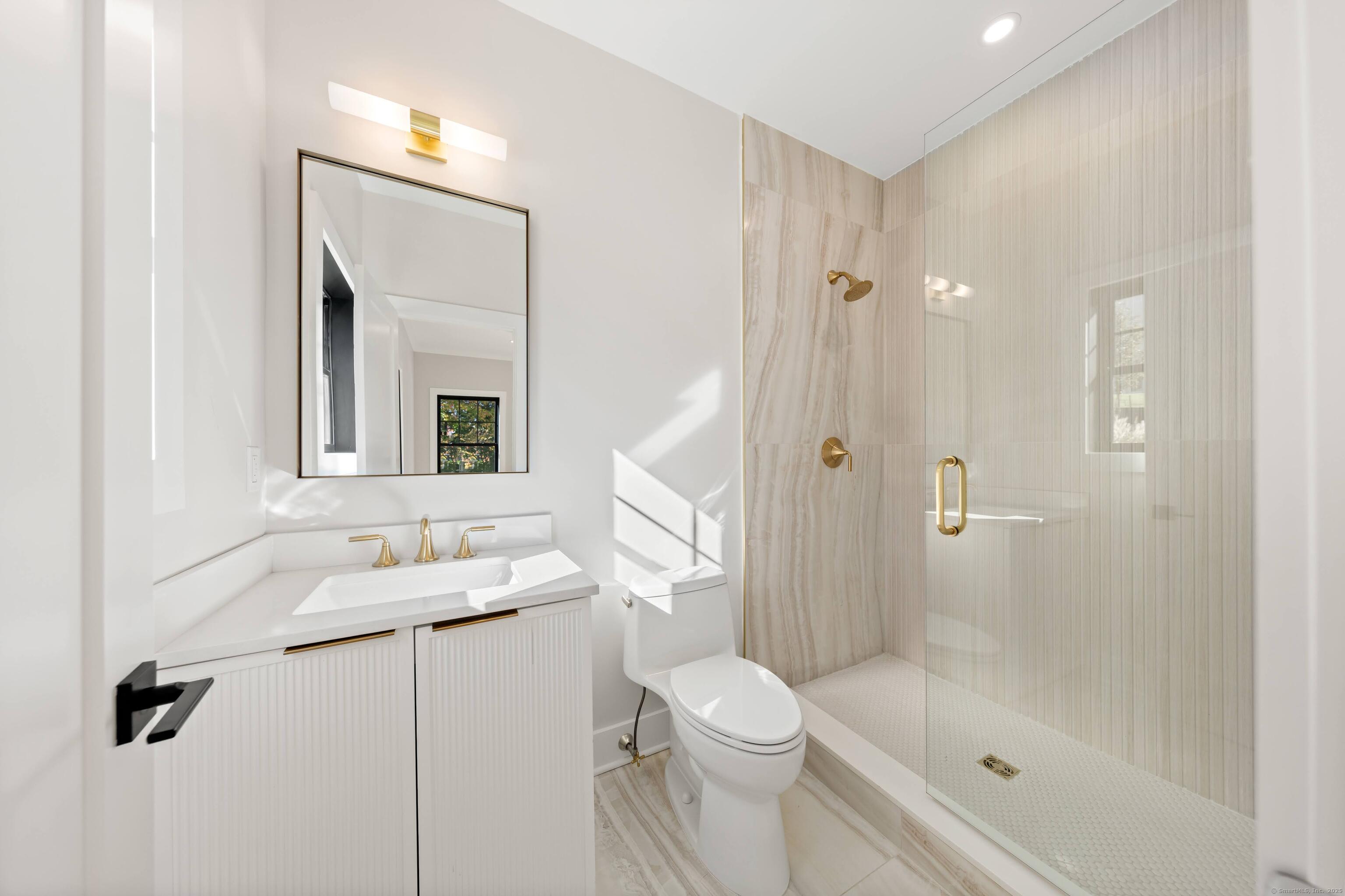 31 Gray Farms Road Stamford, CT 06905 - Photo 20 of 40 a bathroom with a granite countertop sink a toilet and shower