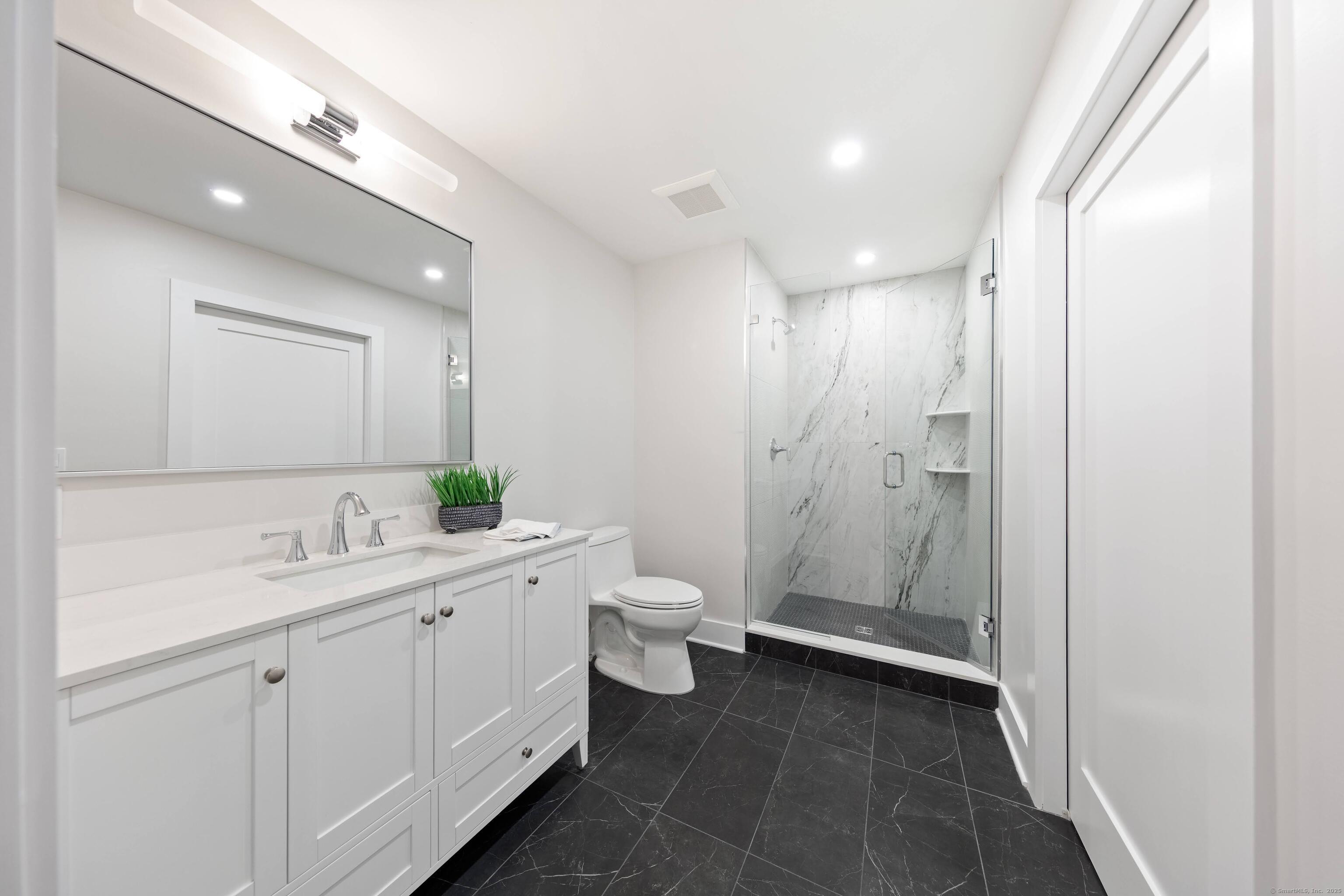 31 Gray Farms Road Stamford, CT 06905 - Photo 34 of 40 a bathroom with a double vanity sink toilet and shower