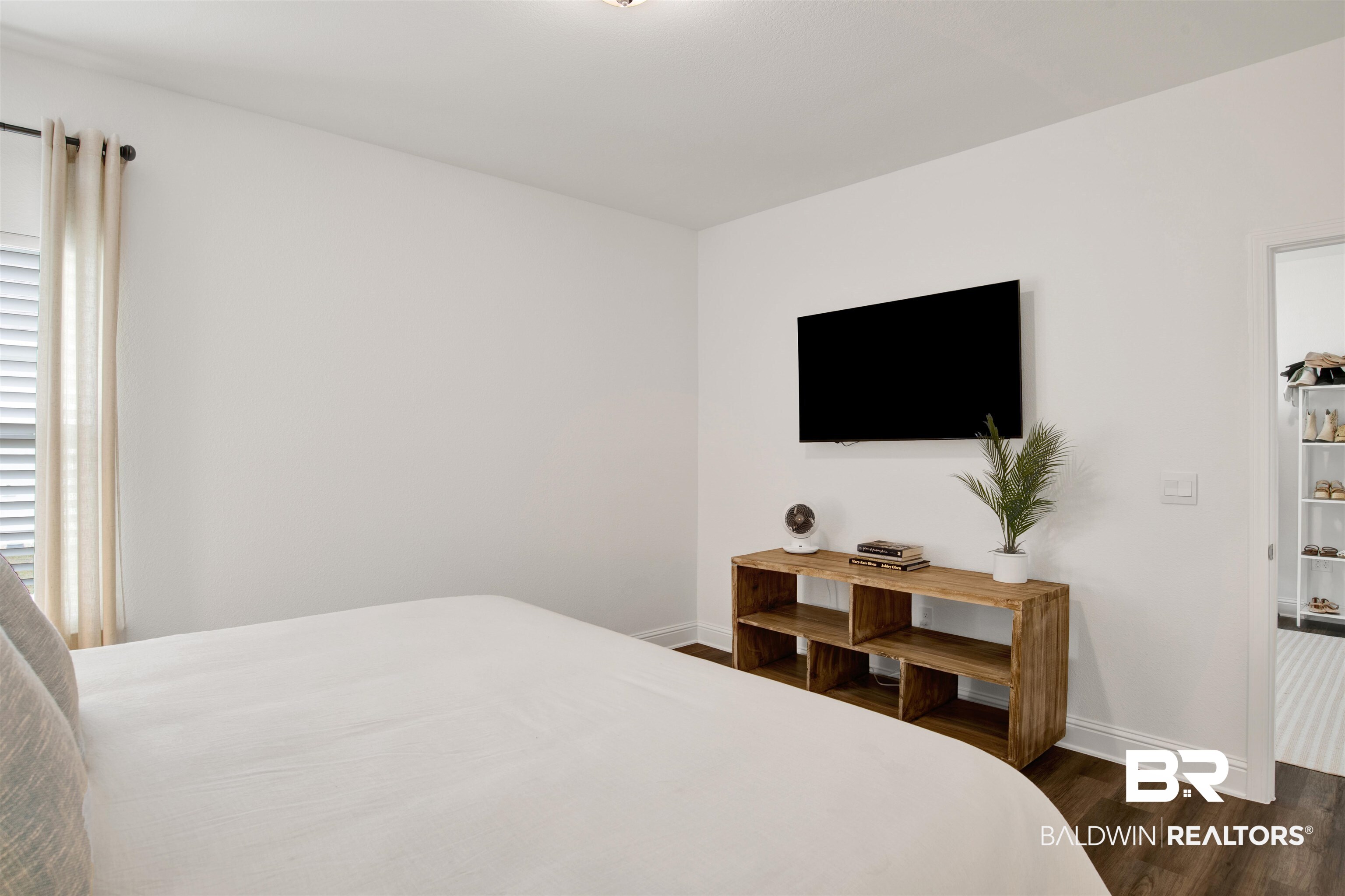 594 Shepard Street Gulf Shores, AL 36542 - Photo 13 of 51 Bedroom with baseboards and dark wood-type flooring