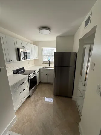 a kitchen with a refrigerator stove and microwave