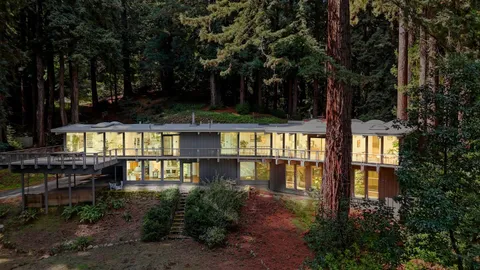 a view of a house with large pool and sitting area