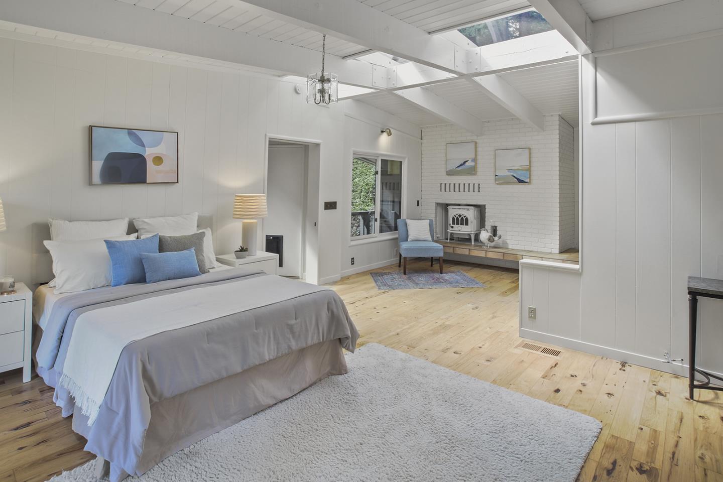 320 Grandview Drive Woodside, CA 94062 - Photo 14 of 43 a spacious bedroom with a bed a couch and dresser