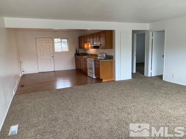 3675 Neil Road Reno, NV 89502 - Photo 2 of 6 a view of kitchen with granite countertop cabinets and refrigerator