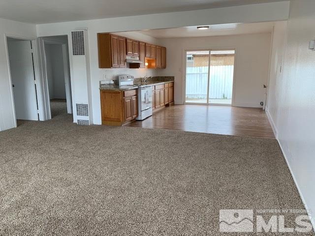 3675 Neil Road Reno, NV 89502 - Photo 3 of 6 a view of a kitchen with a sink and a refrigerator