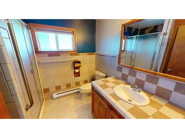 a bathroom with a sink vanity granite and a mirror