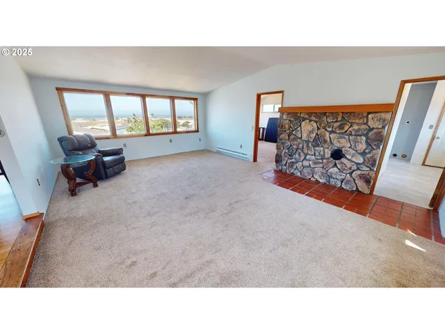 a open living room with a couch and dresser with wooden floor