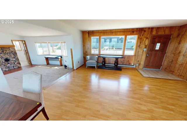 a living room with furniture and large windows